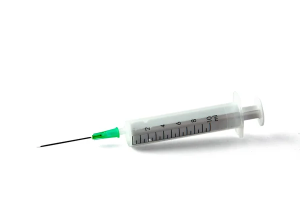 Medical syringe lying the desk, isolated on white background — Stock Photo, Image