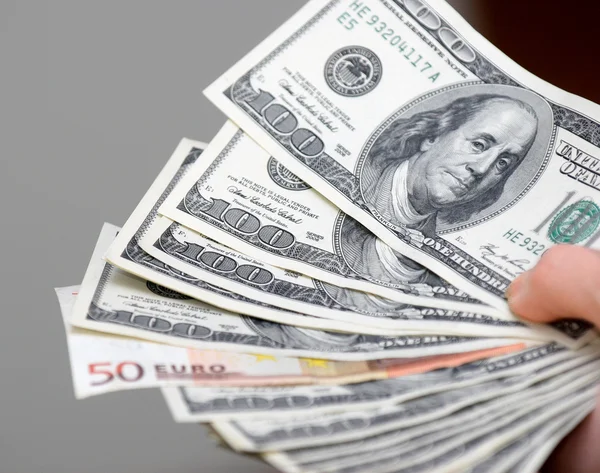 Many dollars falling on man's hand with money, isolated — Stock Photo, Image
