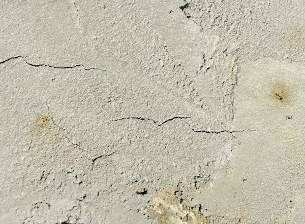 Cracked concrete texture closeup background.