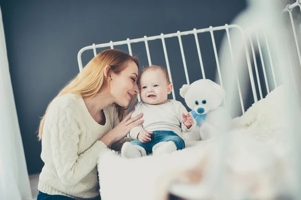 Young mother and baby on the bed — Stock Photo, Image