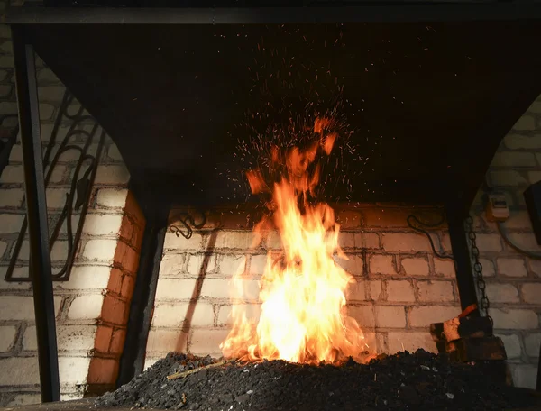 Forjar fuego en el herrero donde se elaboran herramientas de hierro — Foto de Stock