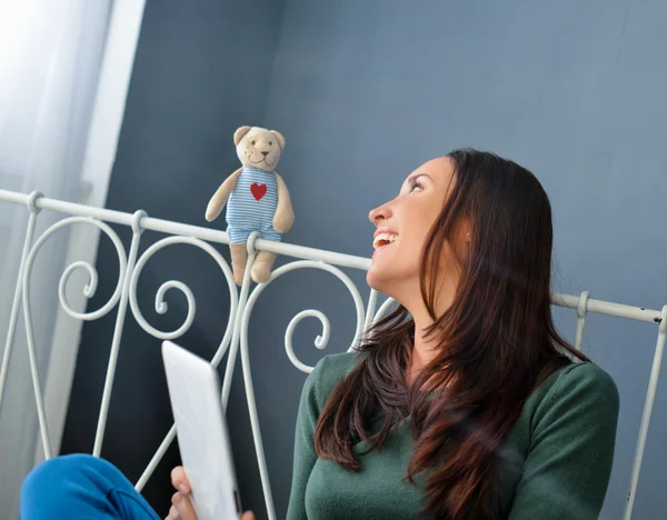 Young woman using plane-table on her bed — Stock Photo, Image