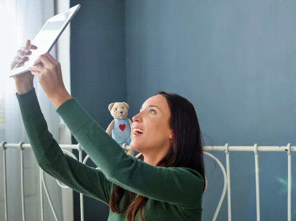 Young woman using plane-table on her bed — Stock Photo, Image