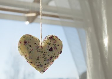 Pencerenin önünde asılı kalp dekorasyon