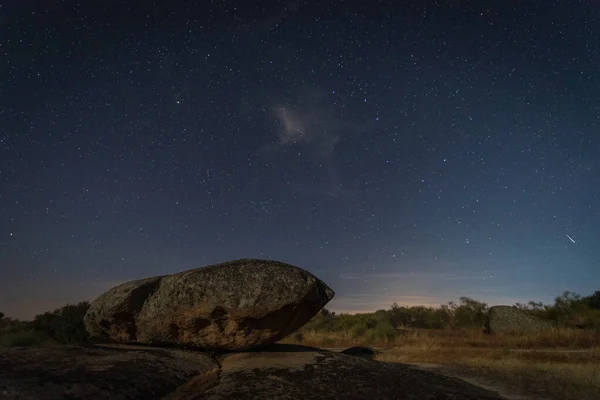 Shooting star. Night photography in the Natural Area of Barruecos. Extremadura. Spain.