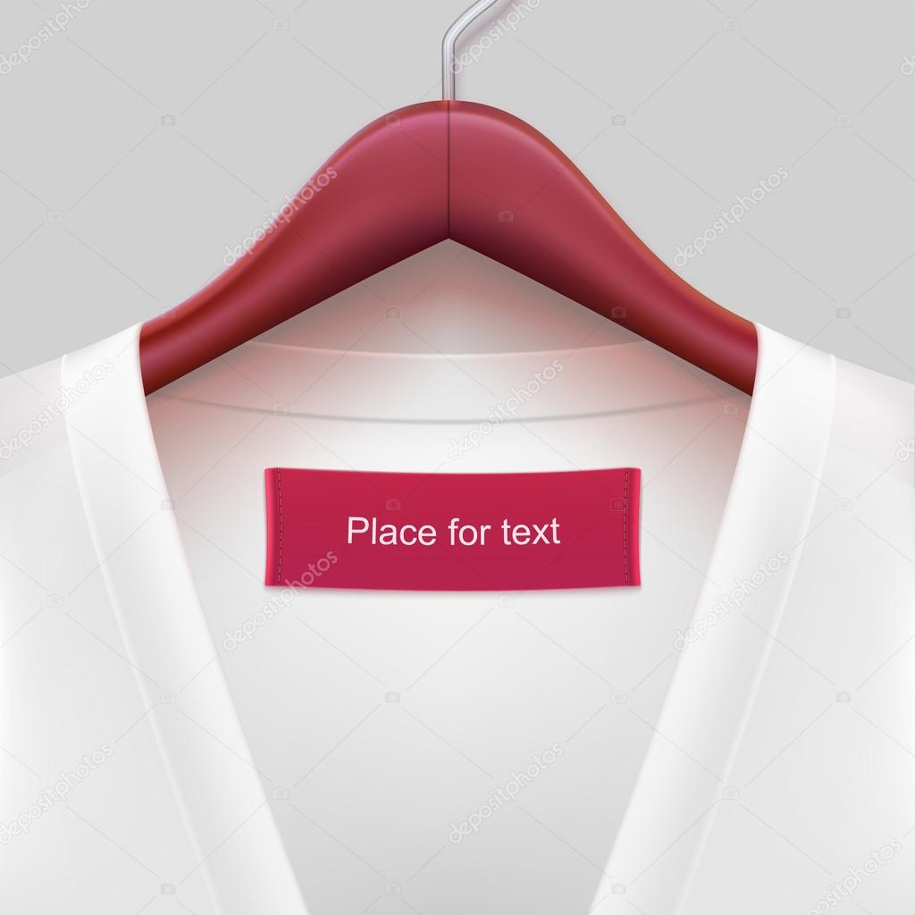 Jacket with label hanging on a hanger.