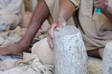 Erkek bir Mısırlı heykeltraşın elleri kaymak kaymaktaşı ile yakından çalışırken.