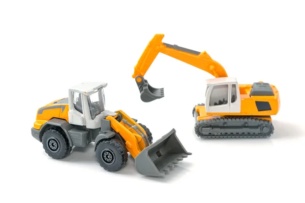 Carro de brinquedo e caminhão de construção no fundo — Fotografia de Stock