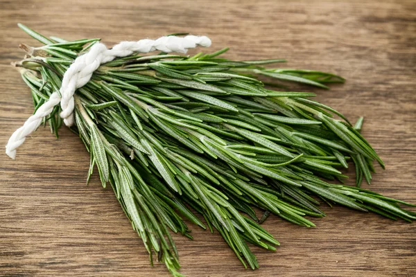 Rosemary bound on a wooden board — Stock Photo, Image