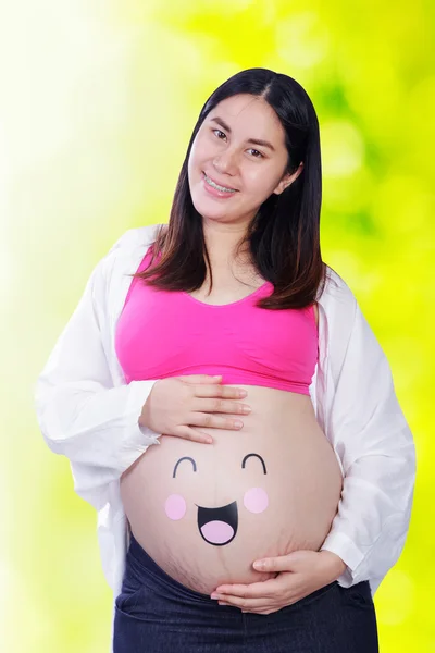 Happy těhotná žena s emotikony na břiše — Stock fotografie