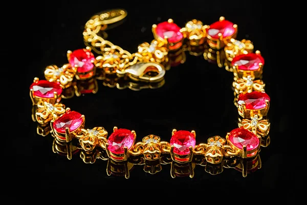 Ruby gold bracelet isolated on black background — Stock Photo, Image