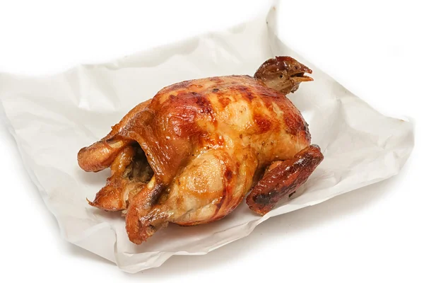 Roasted chicken on white paper — Stock Photo, Image