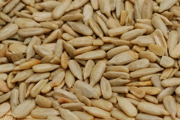 Peeled sunflower seeds background — Stock Photo, Image