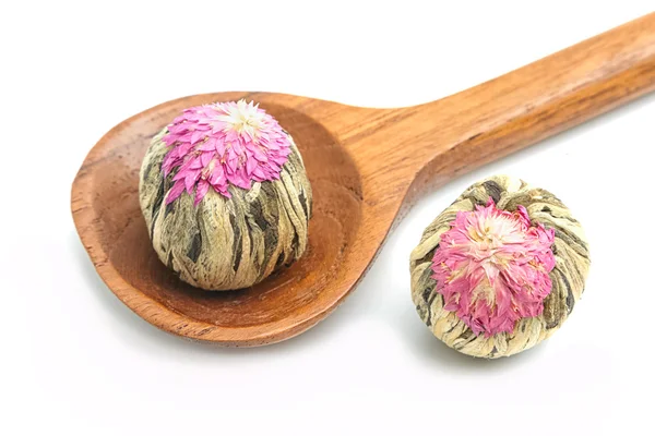 Floral blooming tea balls on wooden spoon isolated on white — Stock Photo, Image