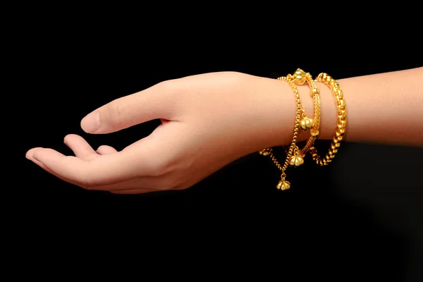 Frau Hand halten Goldarmband Schmuck isolieren auf schwarz isolieren — Stockfoto
