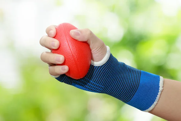 Patient 's woman hand squeezing a stress balls — Stock Photo, Image