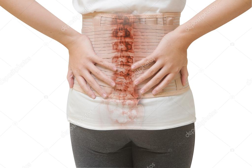 Woman in back pain from spinal injury wearing lumbar brace corse