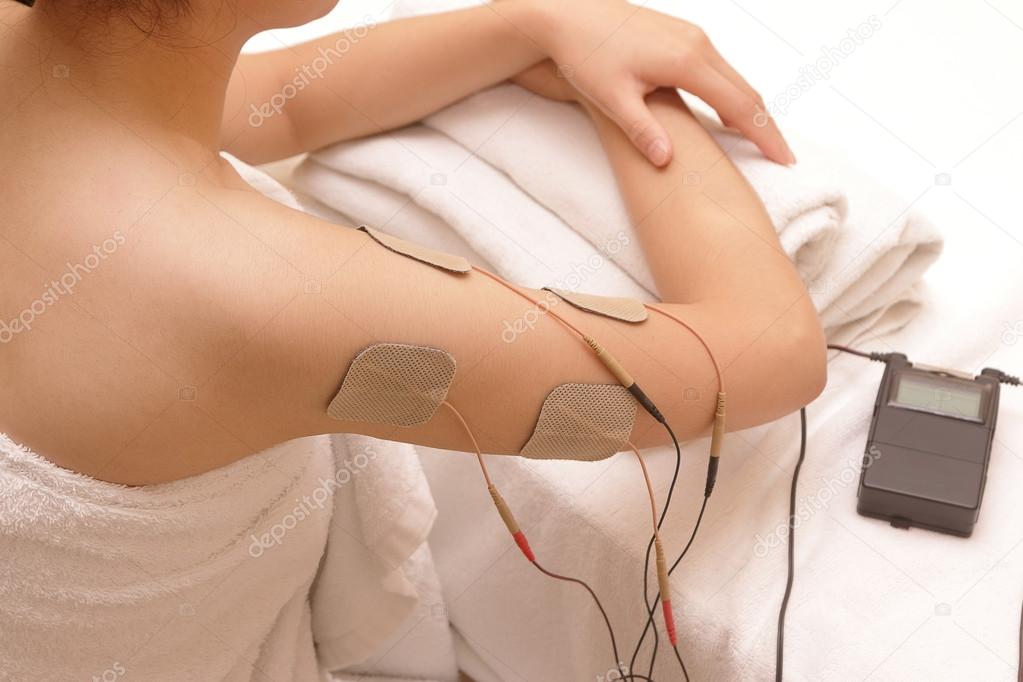 Asian woman is doing massage of electrical -stimulation ( TENs )