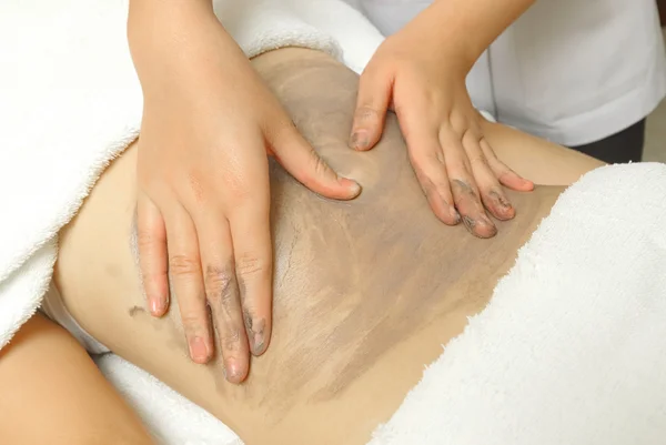 Beautiful girl having clay body massage — Stock Photo, Image