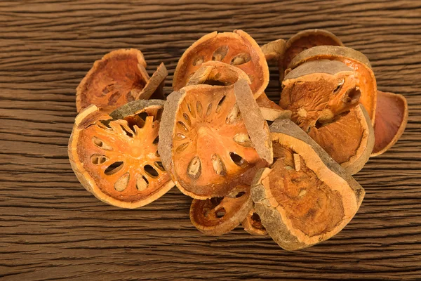 Piece of dried balefruit on wooden board — Stock Photo, Image