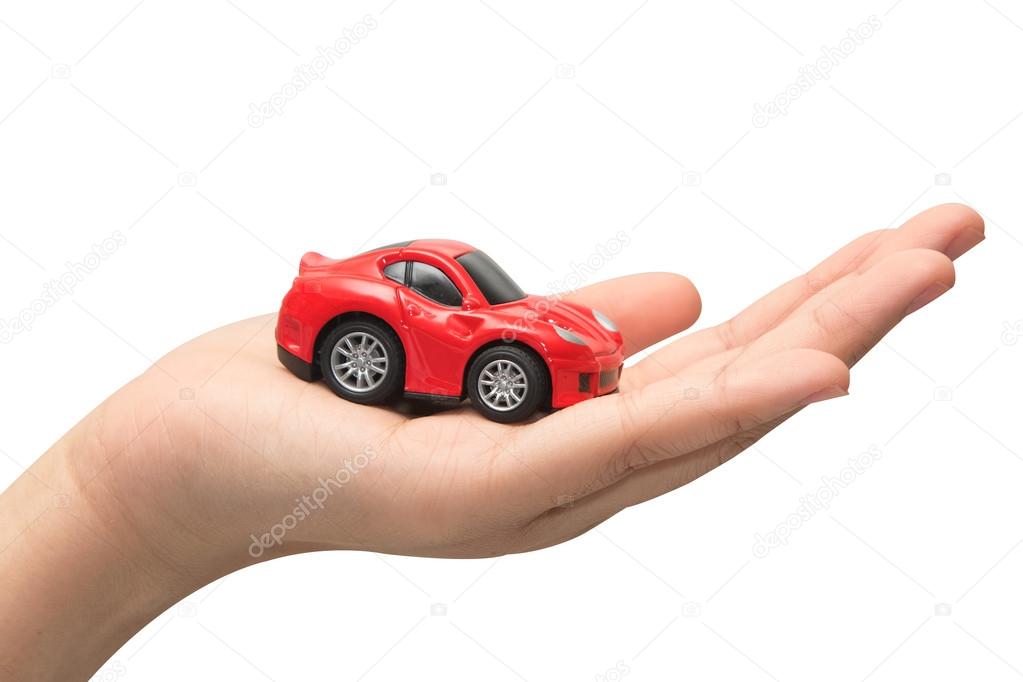 hand holding the model of car. symbol photo for car purchase