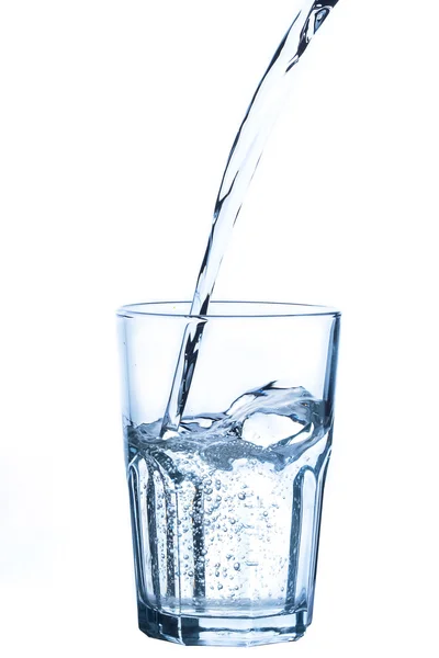 Pouring water into glass on white background — Stock Photo, Image