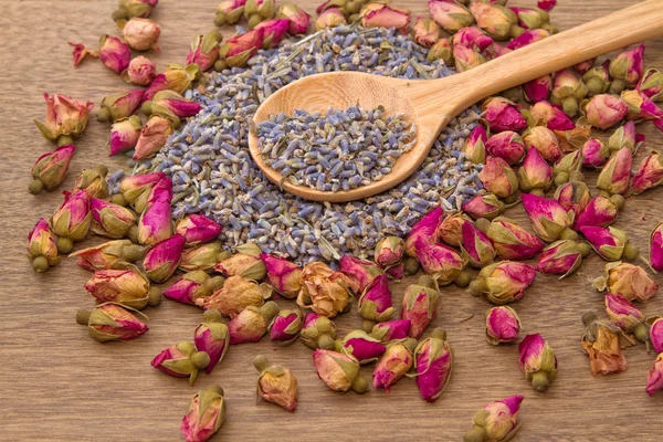 Dried lavender and rose flower tea in wooden spoon — Stock Photo, Image