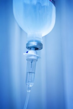 Infusion bottle with IV solution on blue background  clipart