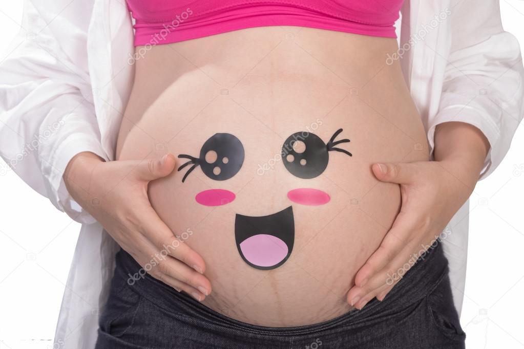 Pregnant woman belly closeup with smiling funny face