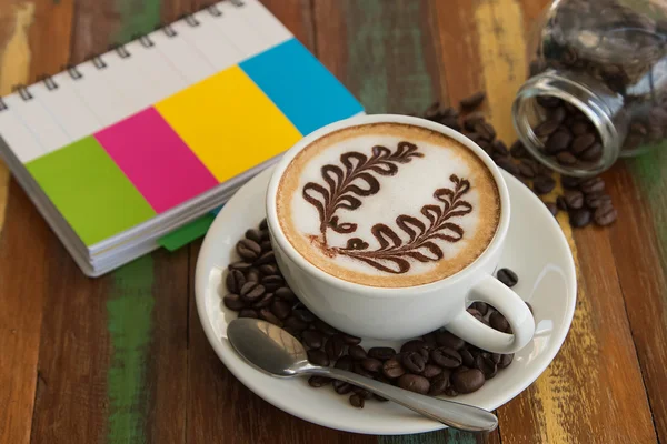 Coffee latte art on the wood desk — Stock Photo, Image