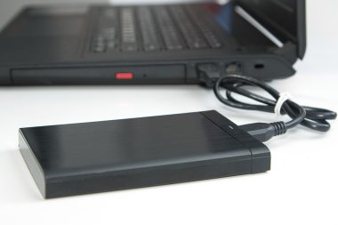  external hard disk connect to computer notebook on white. clipart