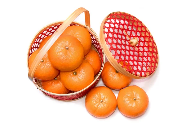 Fresh mandarin oranges in red bamboo basket — Stock Photo, Image