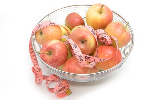 Red apples with pink measuring tape, isolated on white — Stock Photo, Image