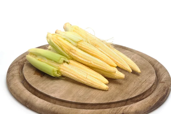 Baby corn on wooden plate on white background — Stock Photo, Image