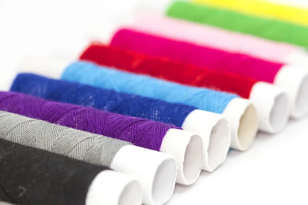 Bobbins with colorful threads on white — Stock Photo, Image