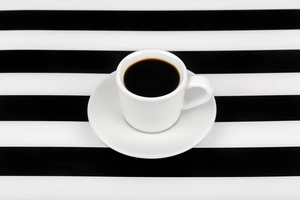 Cup with black drink inside on a black and white background.