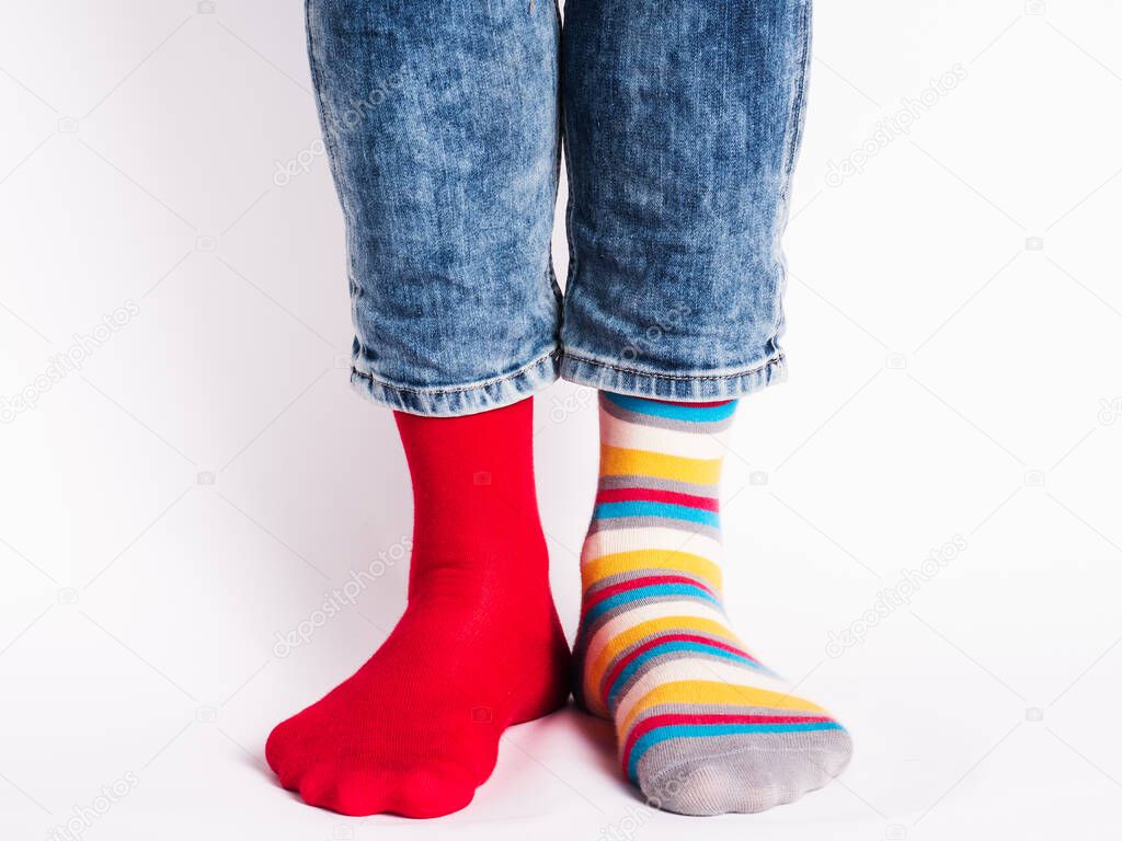 Men's legs and bright socks. Without shoes. Close-up. Style, beauty and elegance concept