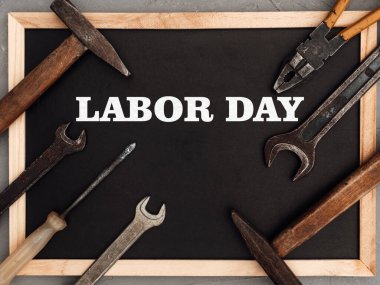 İLK GÜNÜ. El aletleri masanın üzerinde. Yukarıdan bak, yakın plan. Kutlamaya hazırlanıyorum. Sevdiklerinizi, ailenizi, akrabalarınızı, arkadaşlarınızı ve iş arkadaşlarınızı tebrik ederim. Ulusal tatil konsepti