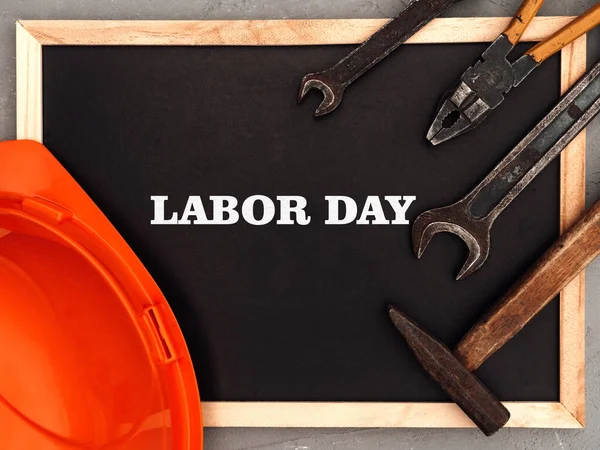 LABOR DAY. Hand tools lying on the table. View from above, close-up. Preparing for the celebration. Congratulations to loved ones, family, relatives, friends and colleagues. National holiday concept