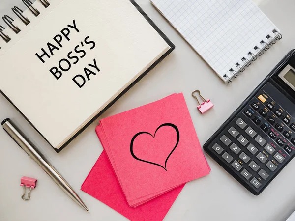 Happy Boss Day. Notepad and stationery lying on the table. Close-up, view from above, no people. Congratulations for loved ones, relatives, friends and colleagues. Holiday concept