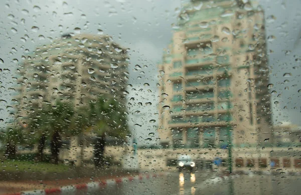 The first rains in Israel. View through the window to the first rain and wet streets