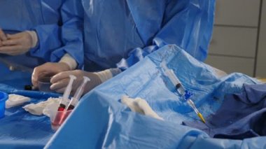 Damar ameliyatı. Radyolog anjiyografi makinesiyle endovasküler ameliyat yapıyor. Doktor rahim fibroid embolizasyonu için kontrast sıvısı kullanıyor. Kardiyo-vasküler muayene. 4k video