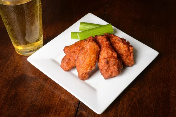 Buffalo Wings with Celery Sticks and Beer — Stock Photo, Image