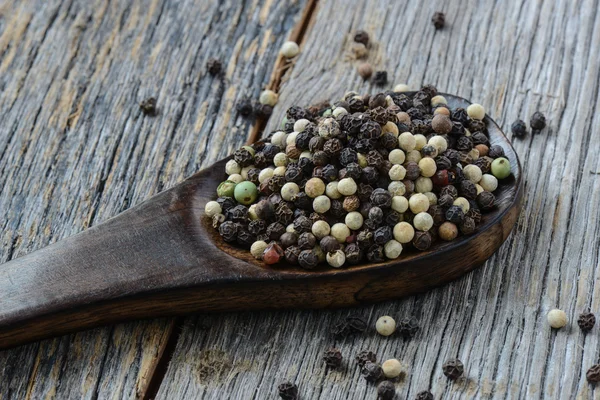 Peppercorn en una cuchara de madera — Foto de Stock