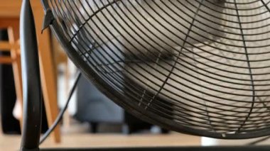 Background of a working air fan in the studio or at home. Household appliances.
