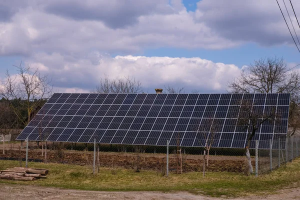 Solar panels in the countryside on a spring day with changeable weather.