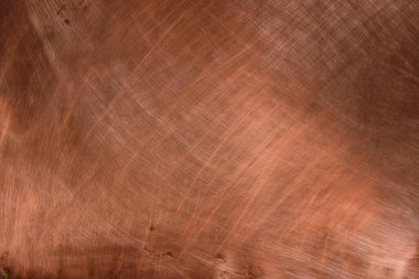 Bakır arka plan harika kırmızı-altın rengi. Işık yansıması. Kaotik çizikler.