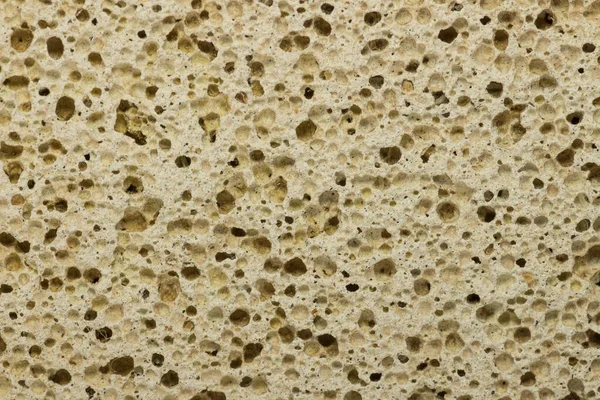 Stone for cleaning heels. A piece of used pumice stone. Close-up.