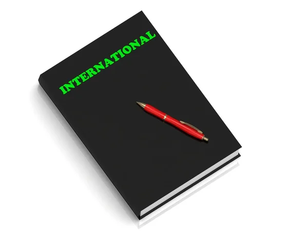 Mezinárodní-nápis zelených písmen na černé knize — Stock fotografie