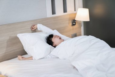 Asyalı kadın sabah uyandıktan sonra esniyor ve esniyor..